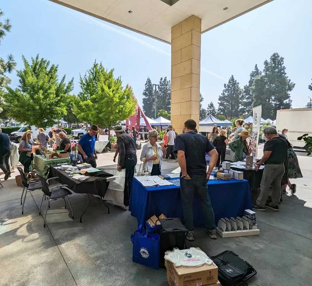 Outdoor community event with exhibit booths and visitors at QuestForDirections.