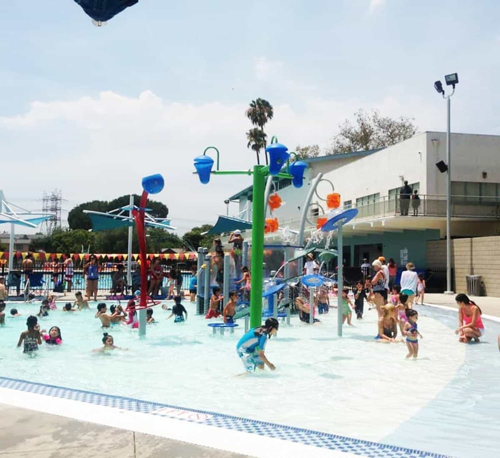 Colorful water playground at family-friendly aquatic center, perfect for kids' summer fun and recreation.