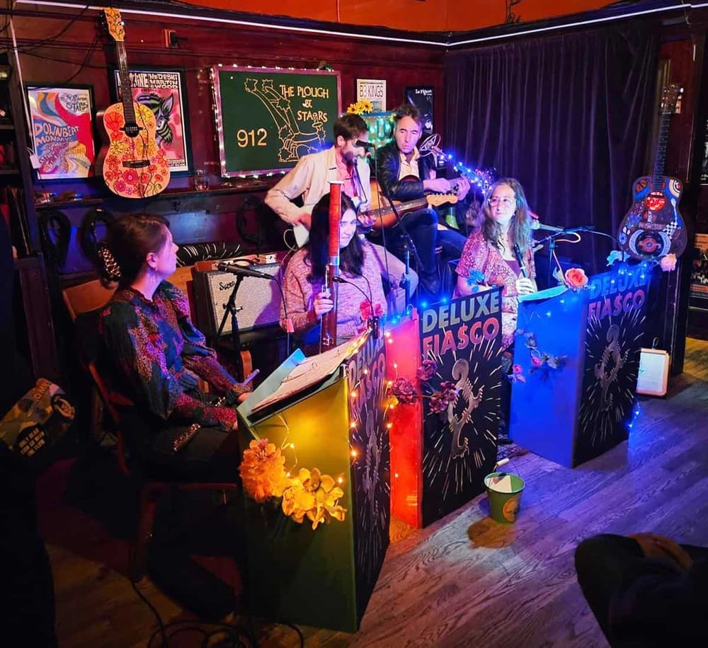 Colorful band performing live music at a cozy, vibrant bar or music venue with guitars and musical decor.