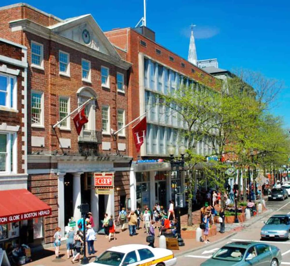 Historic Boston hotel with brick exterior, flags, and bustling street scene.