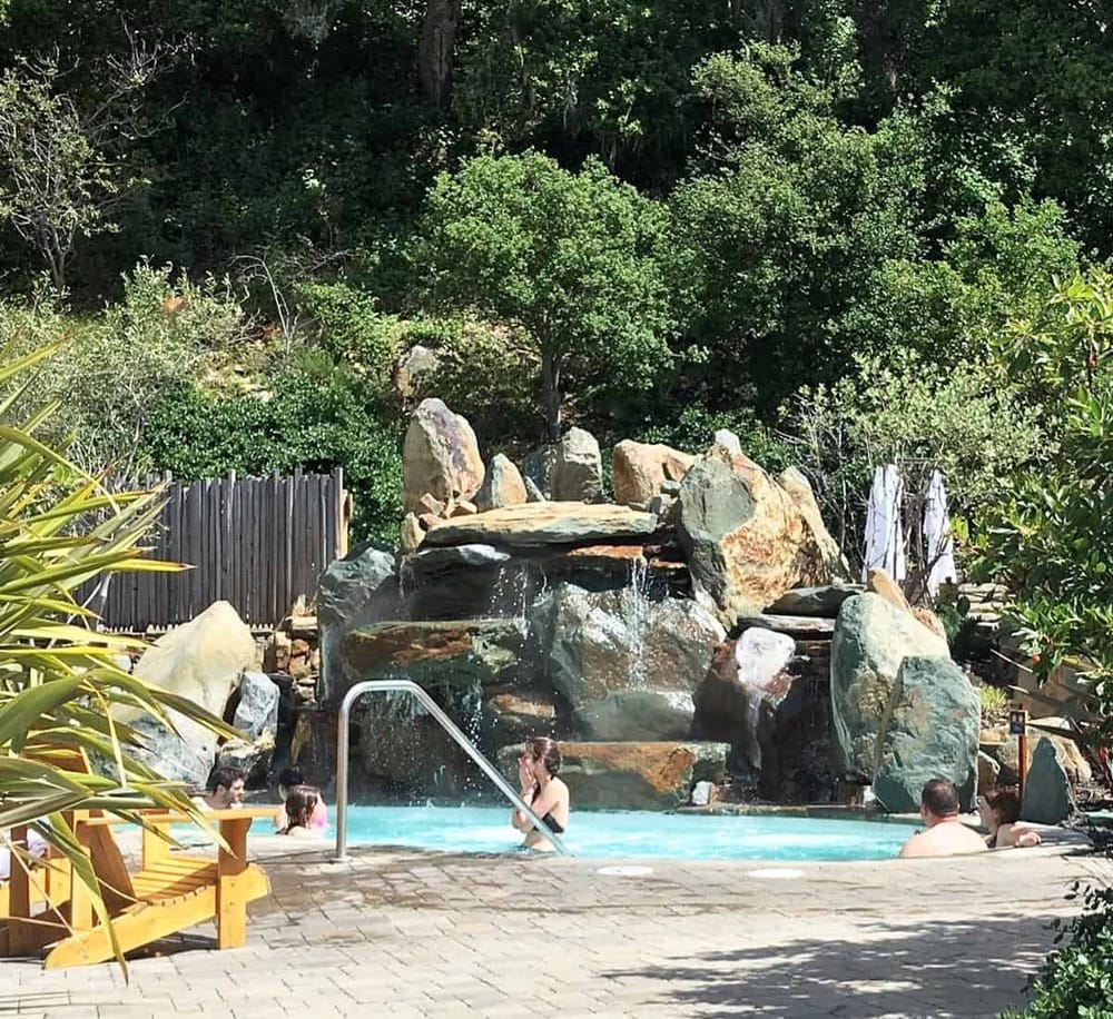 Relaxing outdoor pool surrounded by rocks and lush greenery at QuestForDirections.