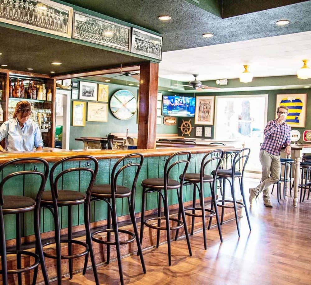Cozy bar interior with wooden accents, vintage decor, and a bar counter for drinks and socializing.