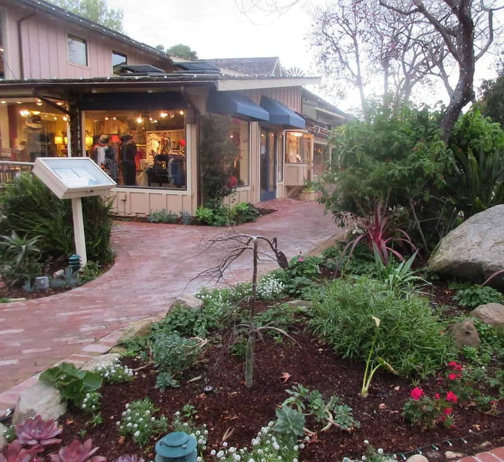 Charming boutique shop exterior with garden pathway, perfect for shopping and exploring local boutiques.