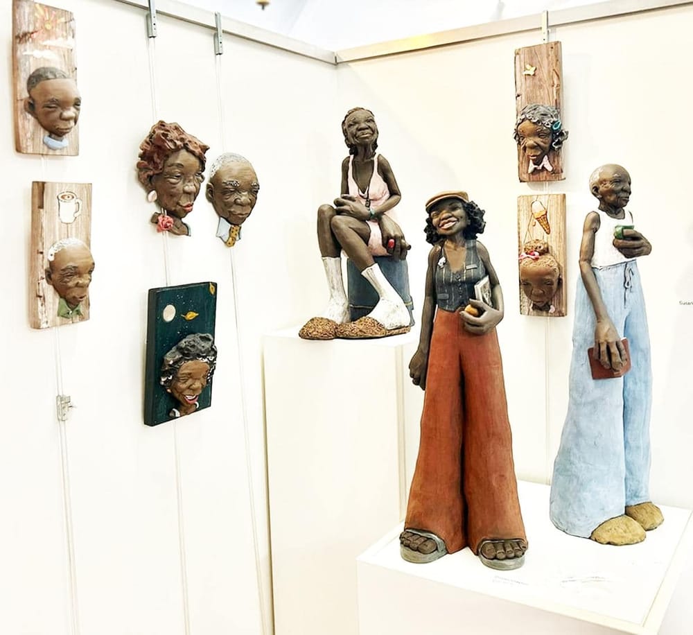 Vibrant artistic sculptures of elderly and young individuals displayed at QuestForDirections art exhibit.