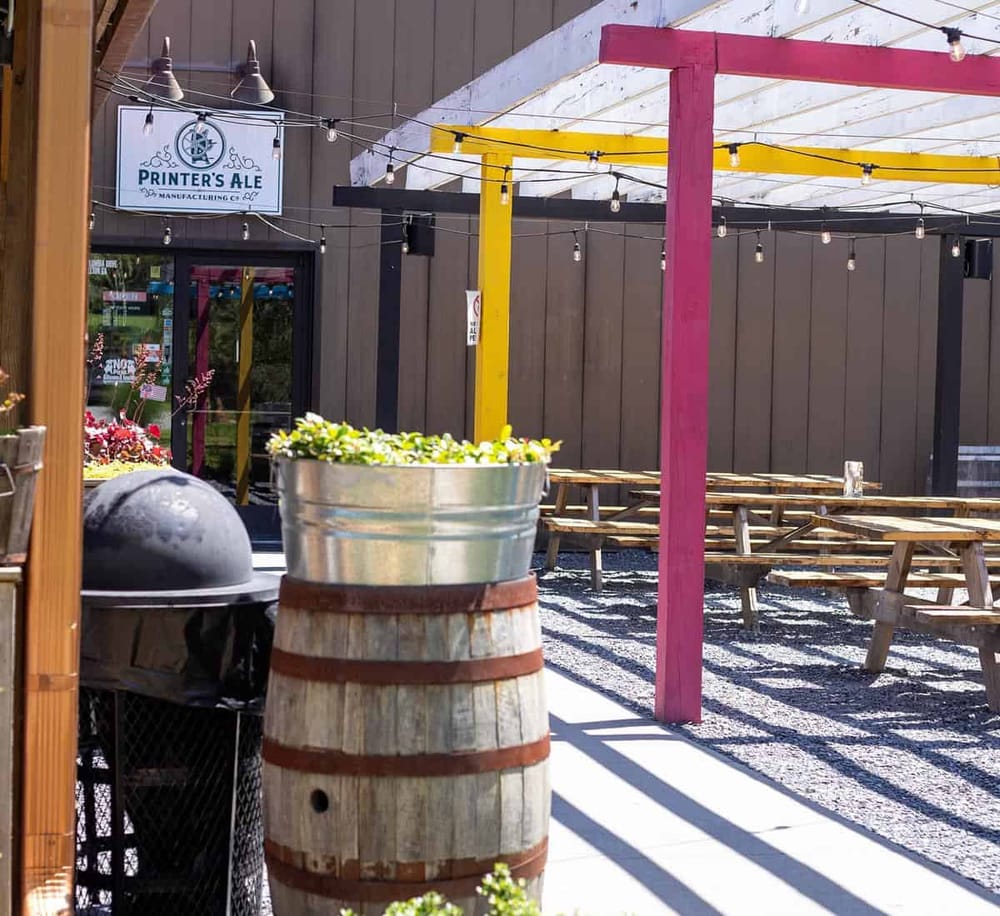 Outdoor beer garden with string lights at Printer's Ale Brewery and Pub.
