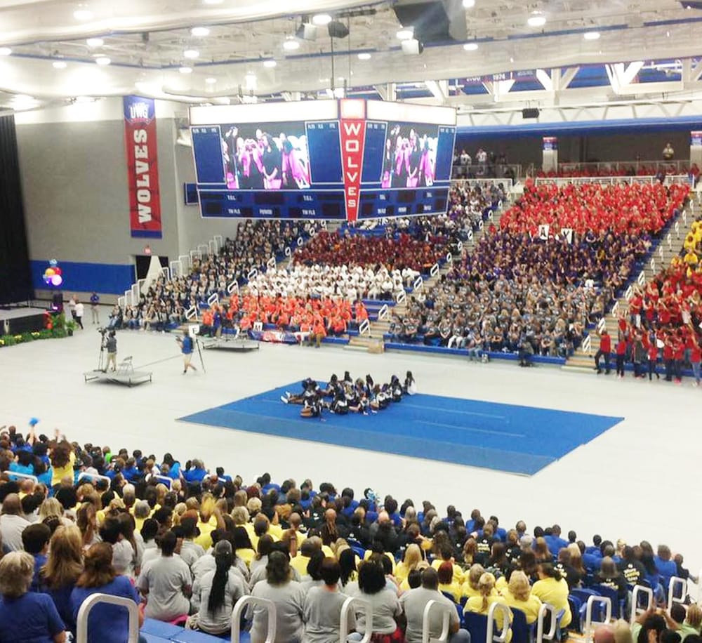 Energetic cheerleading competition at QuestForDirections sports event with vibrant team uniforms.