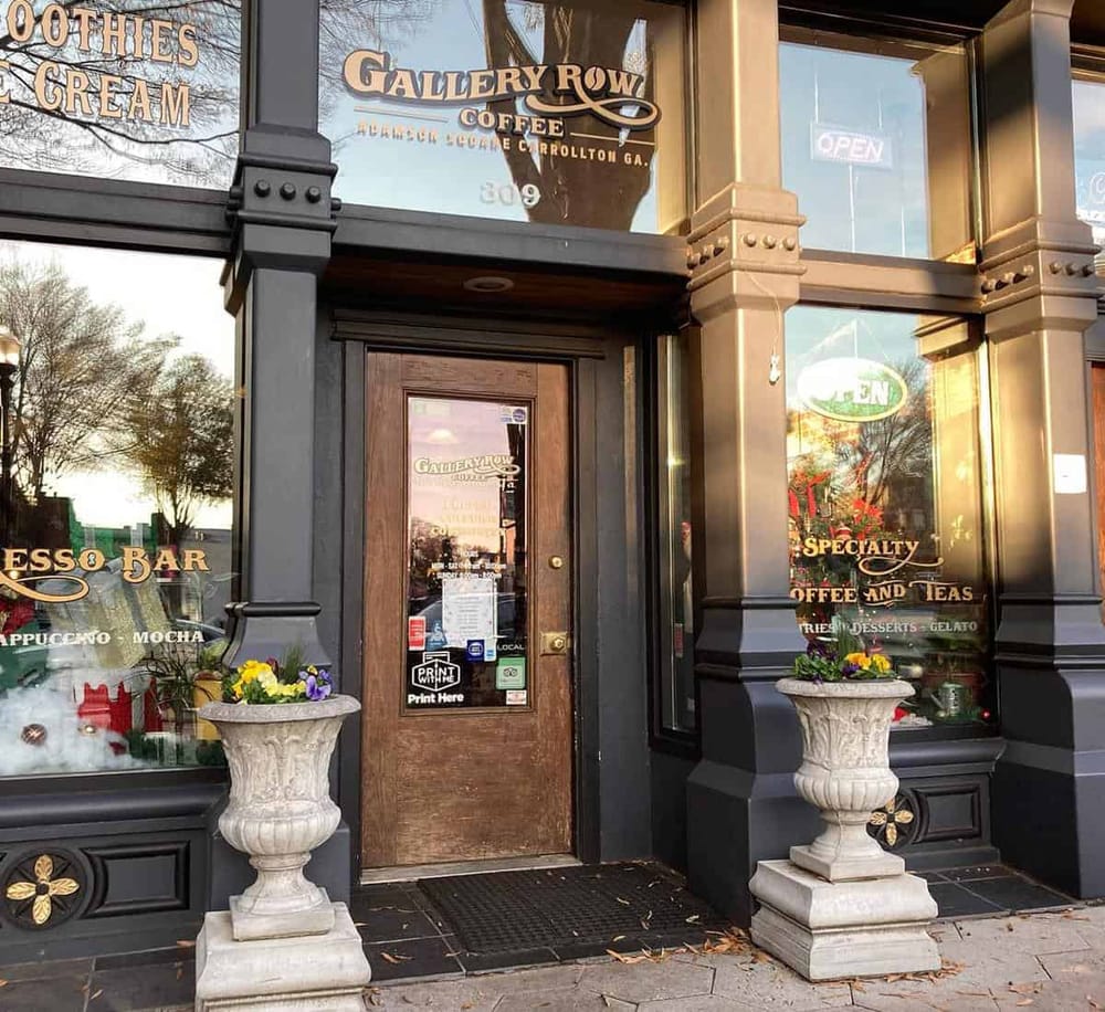 Charming coffee shop entrance with decorative planters and ADA accessible door.