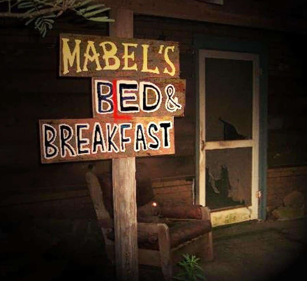 Cozy bed and breakfast sign at Mabel's, perfect for travelers seeking charming accommodations.