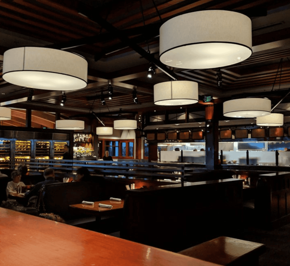 Elegant restaurant interior with modern lighting and cozy ambiance.