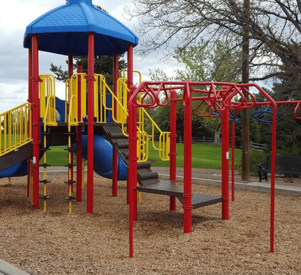 Colorful playground equipment at QuestForDirections park with slides and climbing structures.