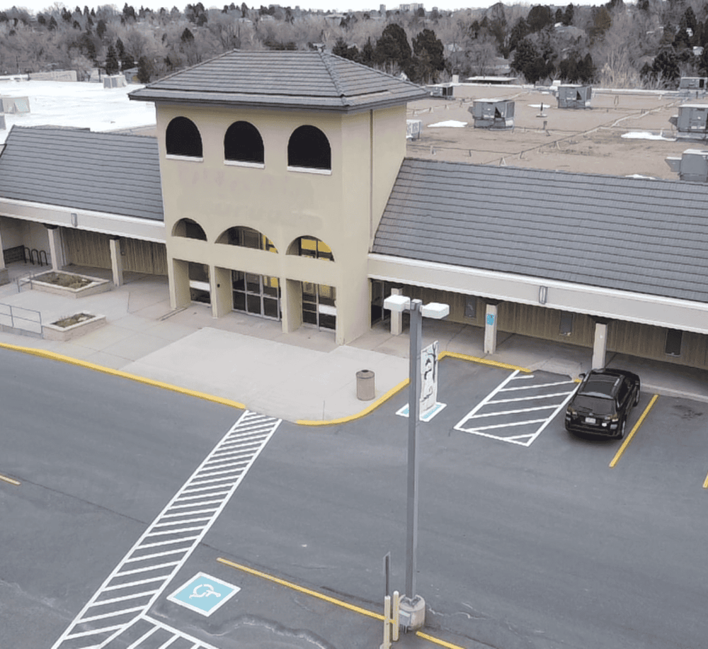 Accessible parking space with wheelchair symbol, exterior of Quest for Directions building.