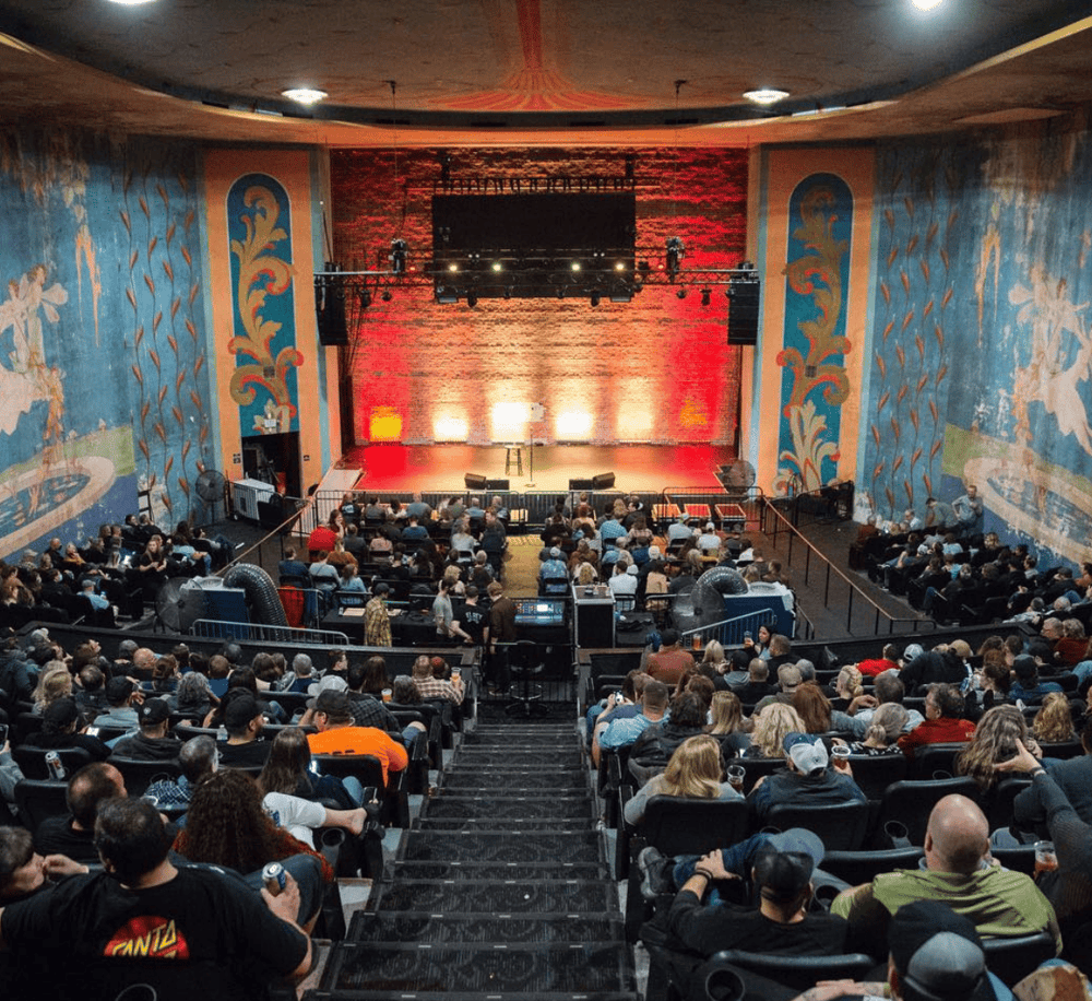 - Vintage theater interior with stage and audience for live events and performances.