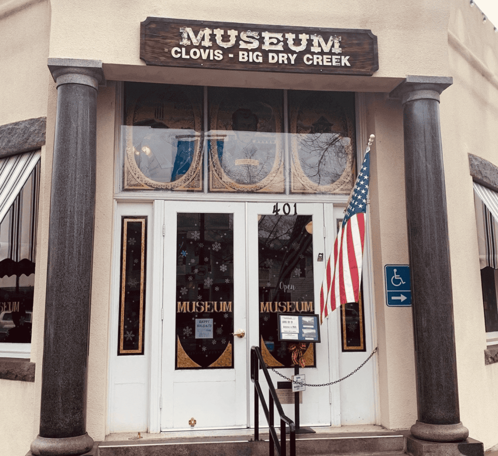 Vintage museum entrance with American flag and handicapped accessibility sign.