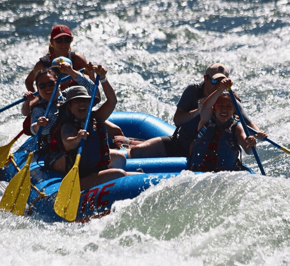 Thrilling whitewater rafting adventure with excited team on rushing river.
