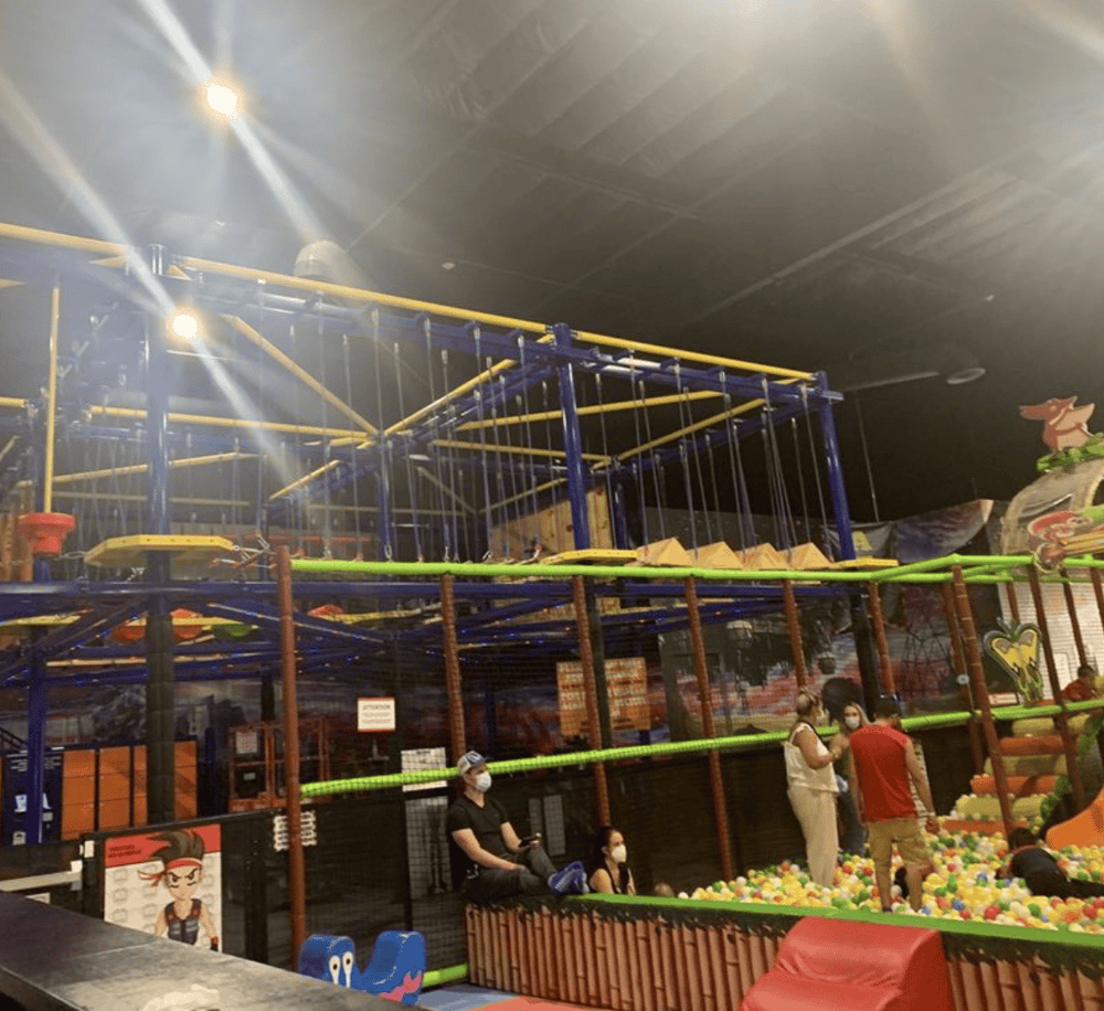 Colorful indoor playground with climbing structures and ball pit at QuestForDirections.