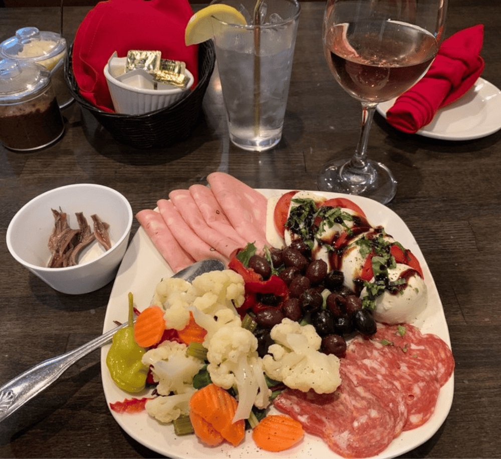 Fresh Italian antipasto platter with assorted meats, cheeses, vegetables, and olives. Perfect for a light, flavorful appetizer.