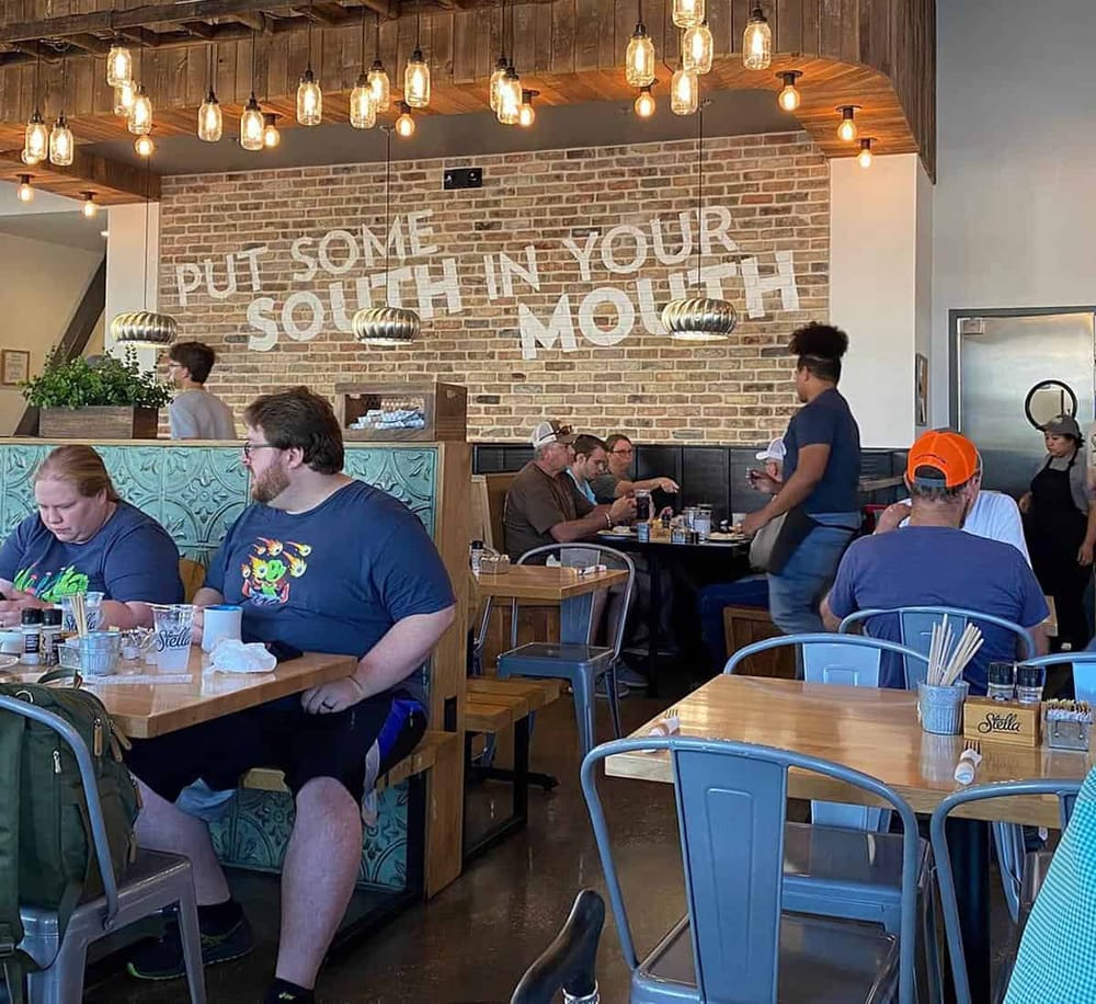 Comfortable dining area inside Quest for Directions, a cozy restaurant with rustic decor and inviting ambiance.