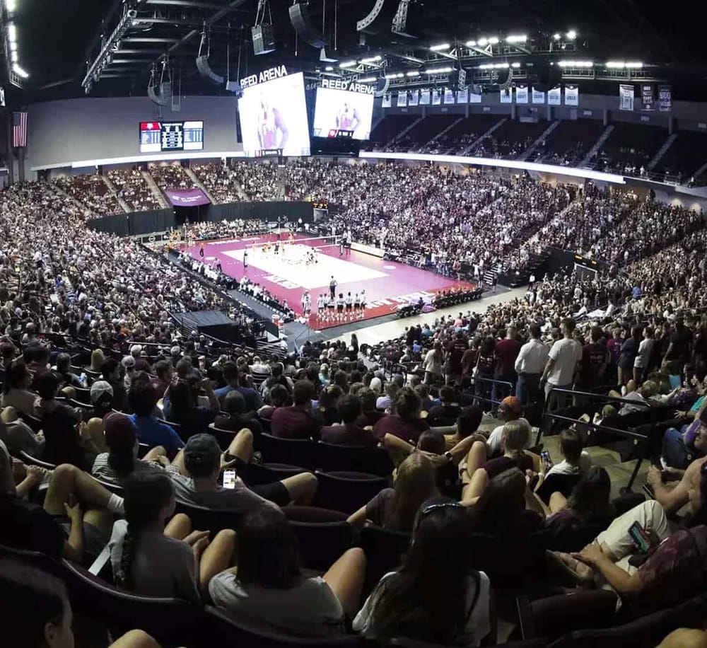Spectator-packed volleyball arena during a match at Quest for Directions stadium.