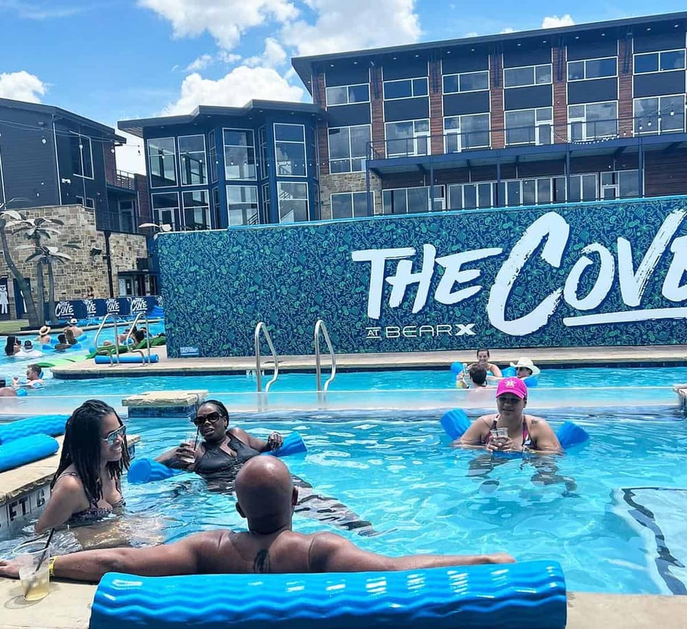 Relaxing pool party at The Cove in BearX, featuring outdoor pools and scenic city views.