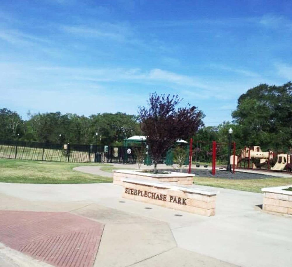 Outdoor park entrance at Stepplechase Park with playground and walking paths, perfect for family recreation and outdoor activities.