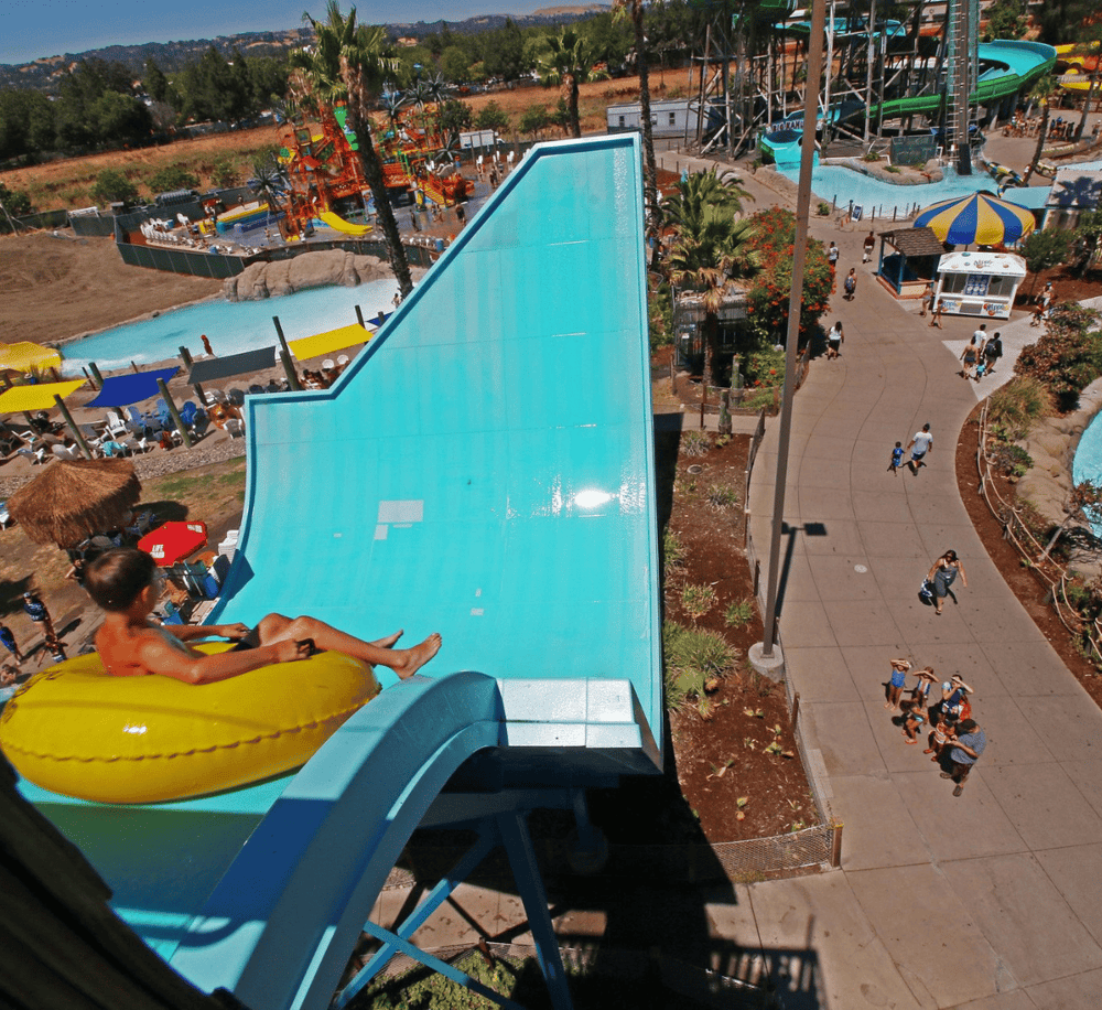 Thrilling water slide at Quest for Directions amusement park, surrounded by water rides and family fun attractions.