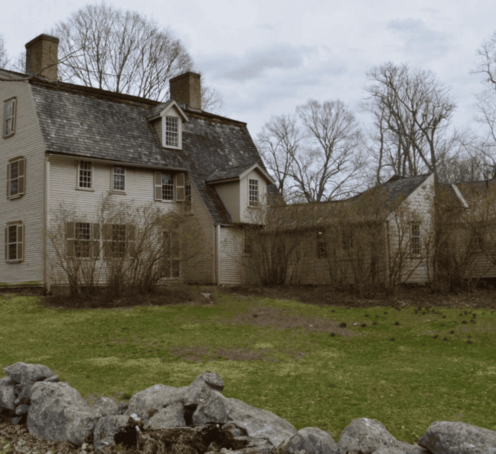 1. Historic old house with wooden siding and chimney in rural setting.