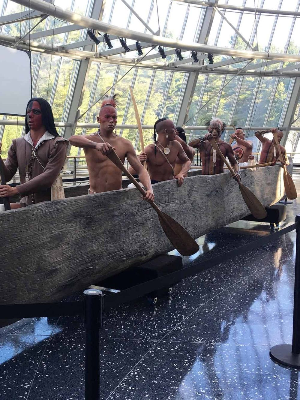 Historic indigenous tribal canoe figures display at the Smithsonian Institution.