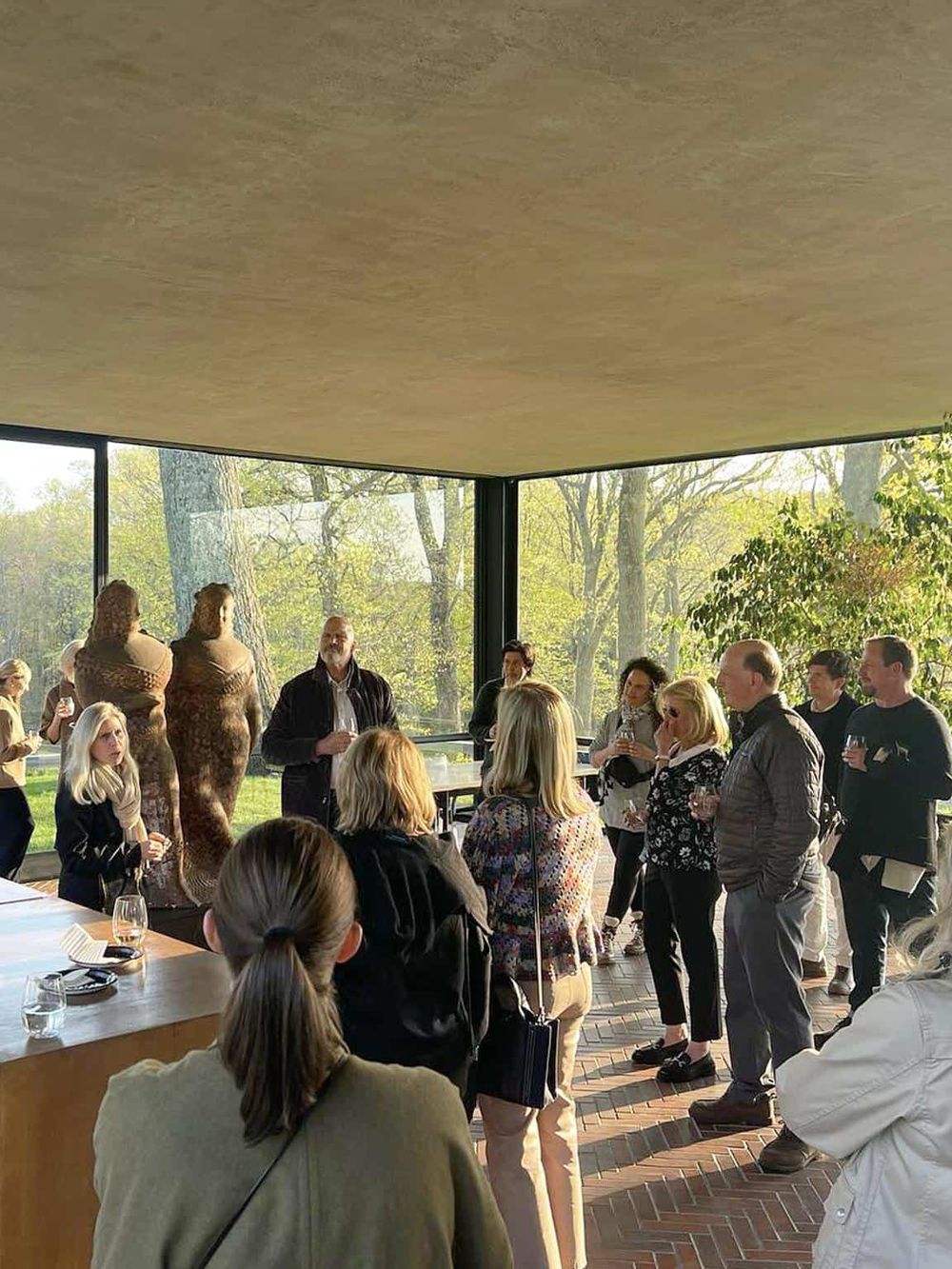 Modern architecture with glass walls at QuestForDirections event showcasing nature views and professional networking.