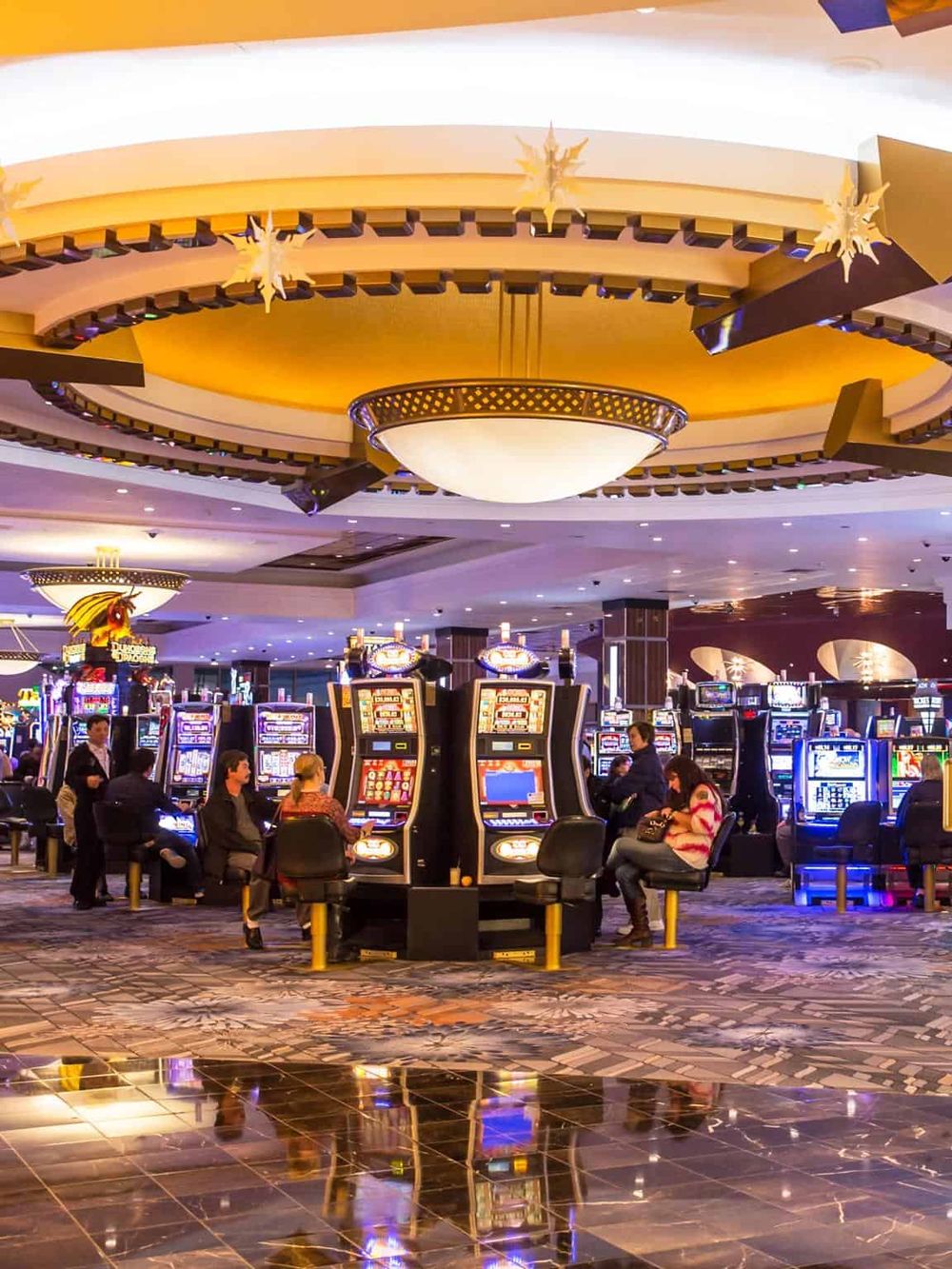 Bright casino gaming area with slot machines and vibrant lighting, perfect for entertainment and fun.