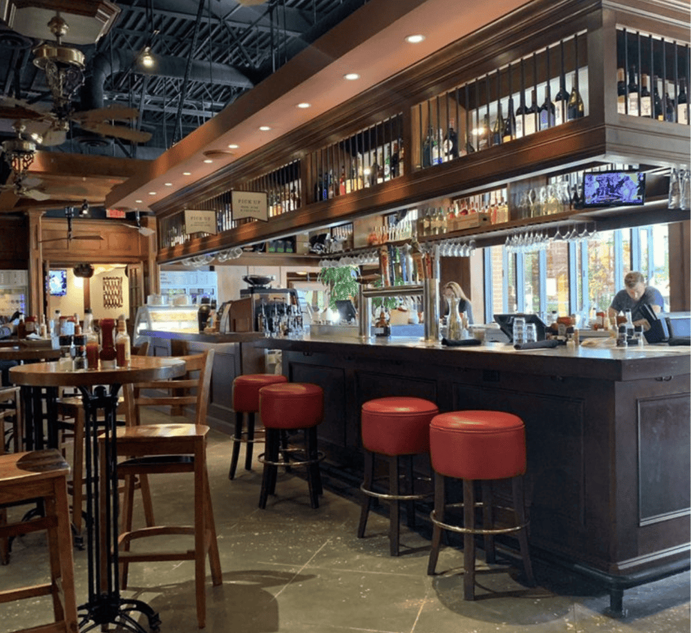 - Cozy bar interior with warm wood accents and modern lighting.