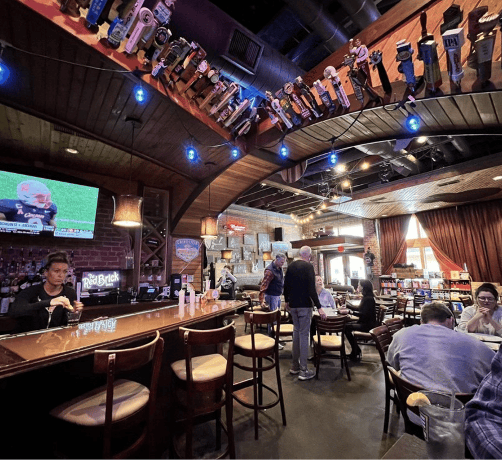 Craft beer bar with TV screens and cozy seating, ideal for sports fans and social gatherings.