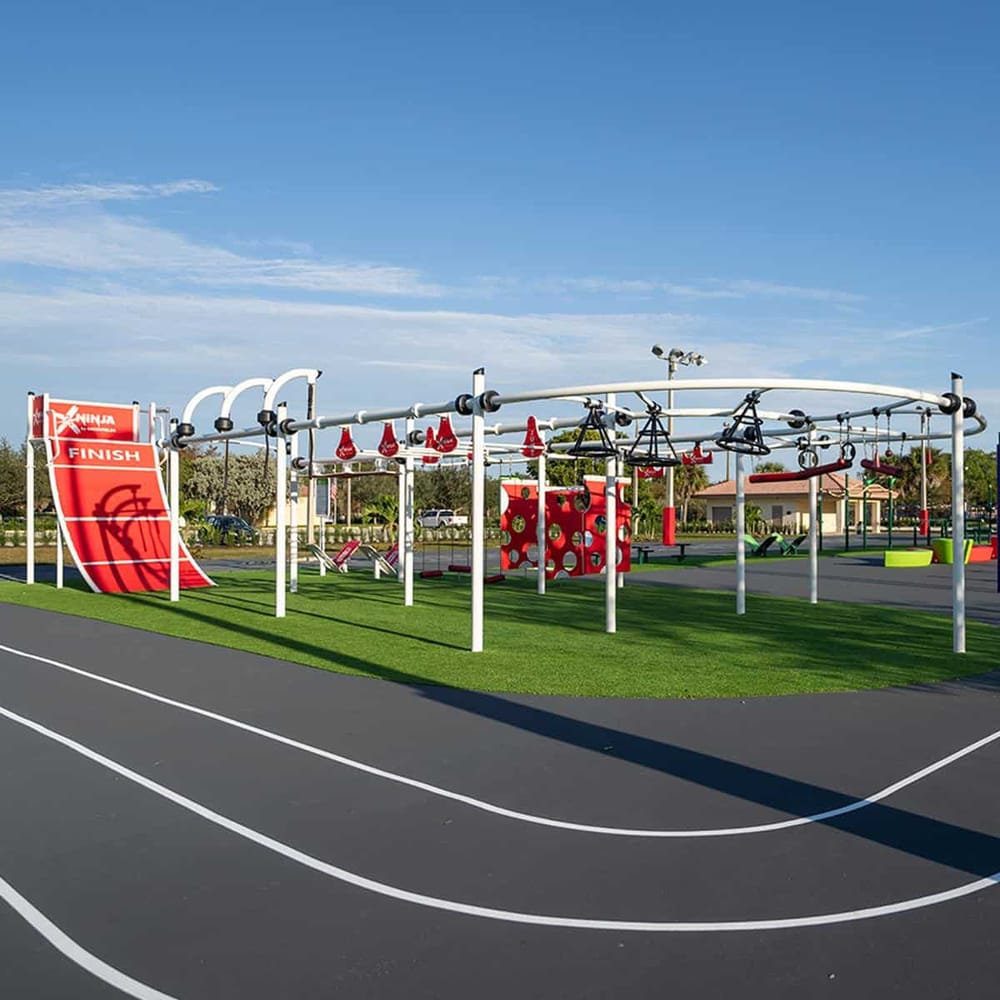 Bright outdoor playground with obstacle course and finish line for kids' fitness and entertainment.