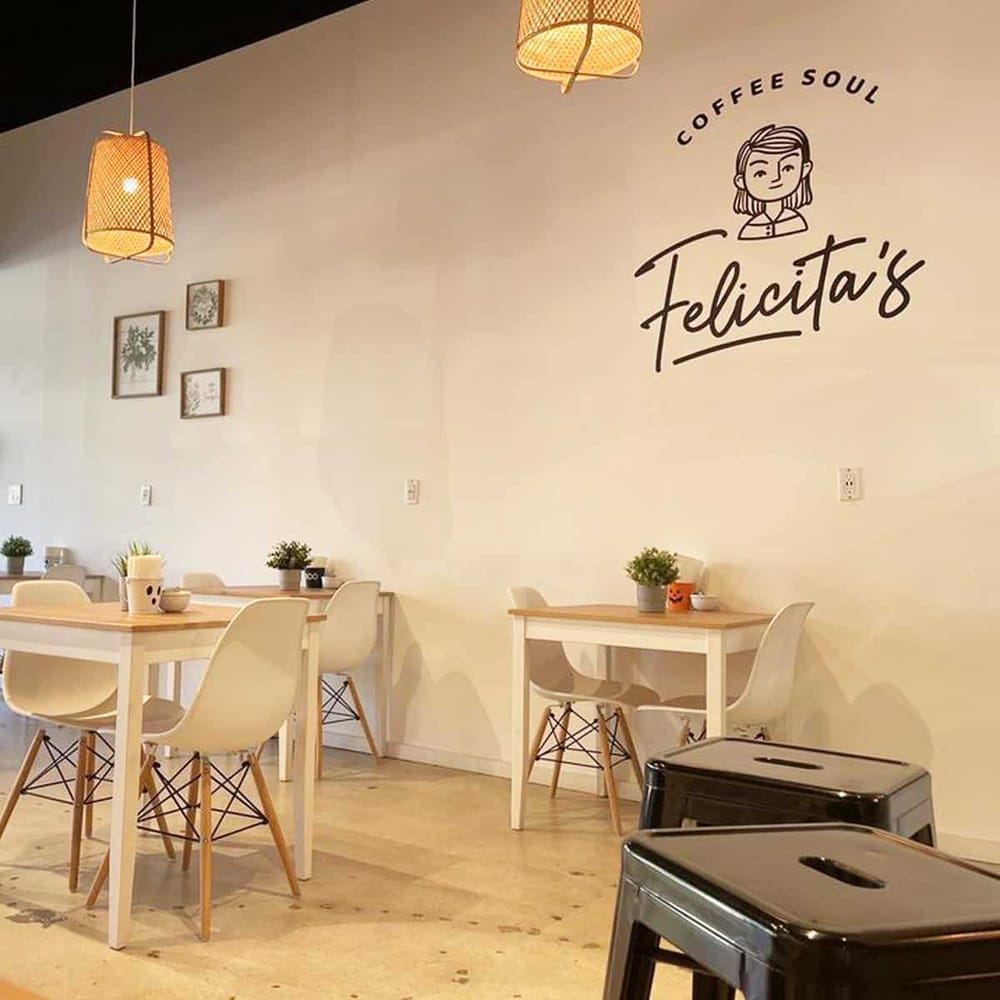Cozy coffee shop interior at Felicita's with modern decor and welcoming atmosphere for coffee lovers.