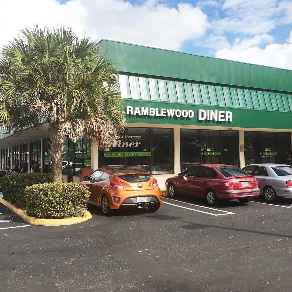 Comfortable diner with parking and tropical landscaping for a relaxing dining experience.