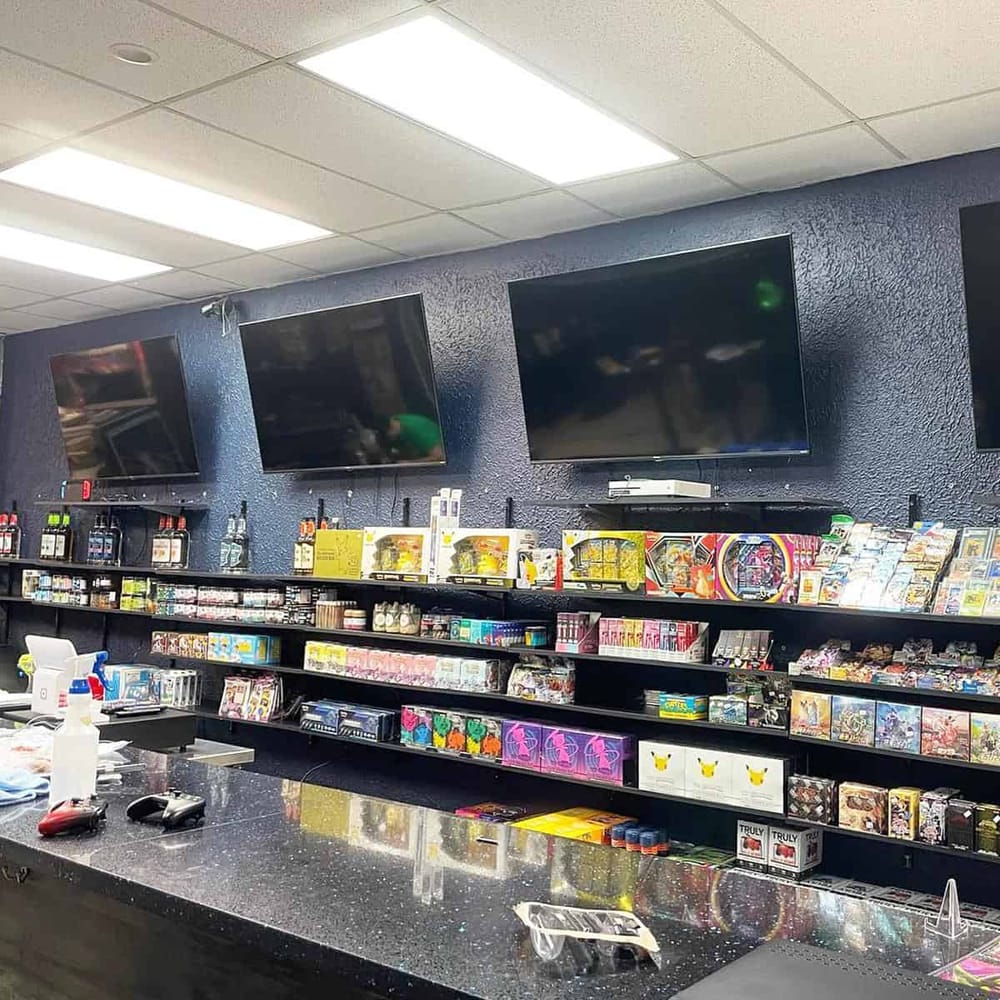 High-tech gaming store with large screens and diverse video game merchandise.