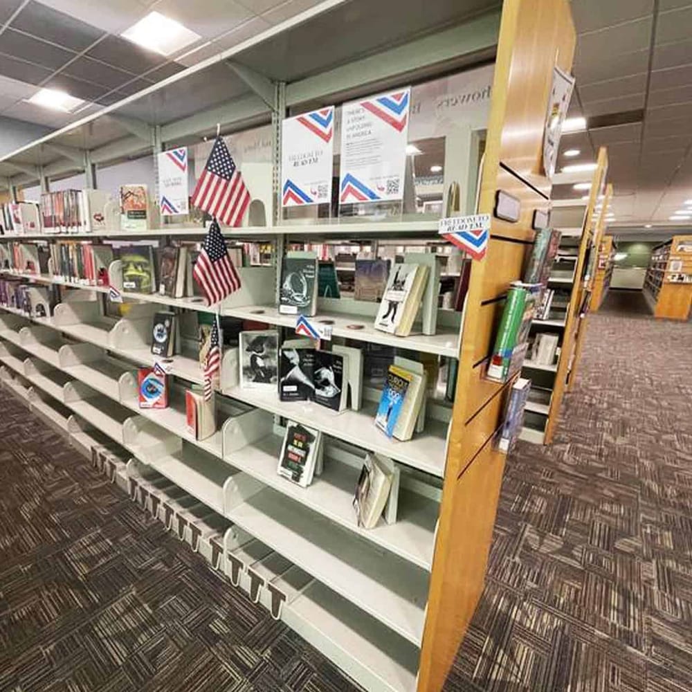 American flag bookstore display with patriotic books in library or retail setting.