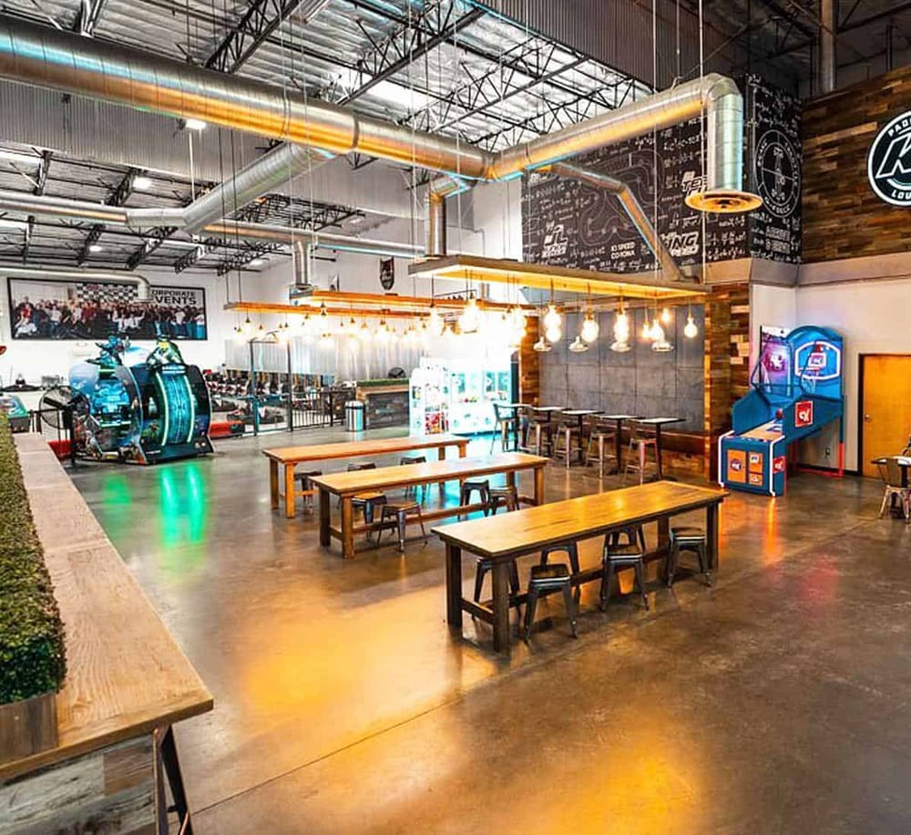 Modern indoor arcade with gaming machines and casual seating at QuestForDirections entertainment center.