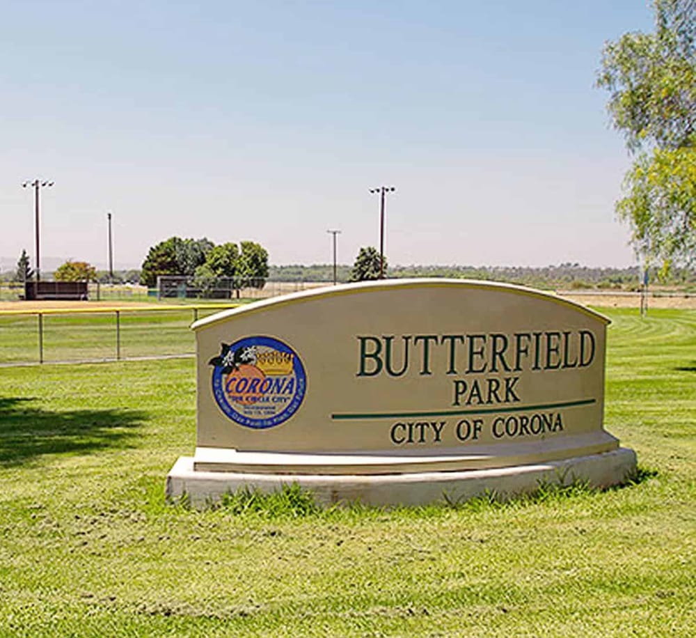 Public park entrance sign at Butterfly Park in Corona, California, offering scenic outdoor recreation and community space.