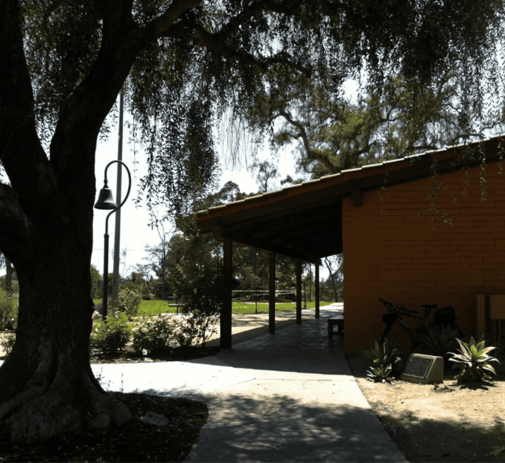 Quiet outdoor park with shaded pathways and seating areas, perfect for relaxation and outdoor activities.