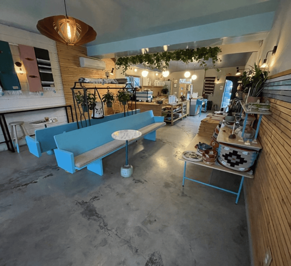 Cozy cafe interior with modern decor, wooden accents, and ambient lighting, perfect for relaxing or working.