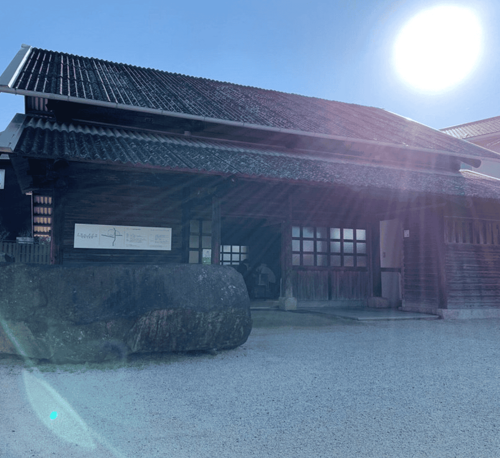 Old Japanese building with traditional architecture and solar-powered design in sunny weather.