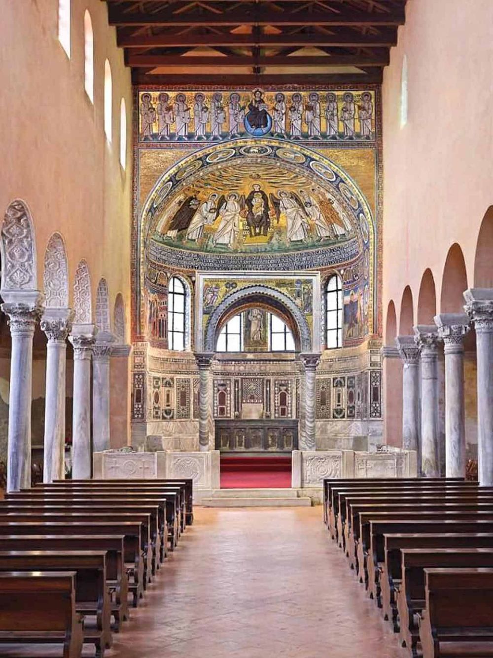 Vibrant church interior with detailed frescoes, ornate architectural elements, and wooden pews.