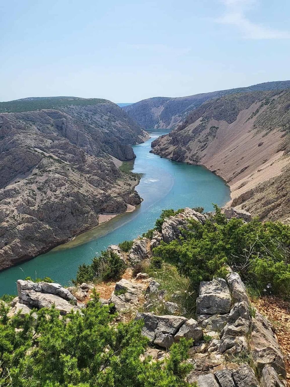 Breathtaking canyon with river view, rugged cliffs, and lush greenery, ideal for outdoor adventure and scenic exploration.