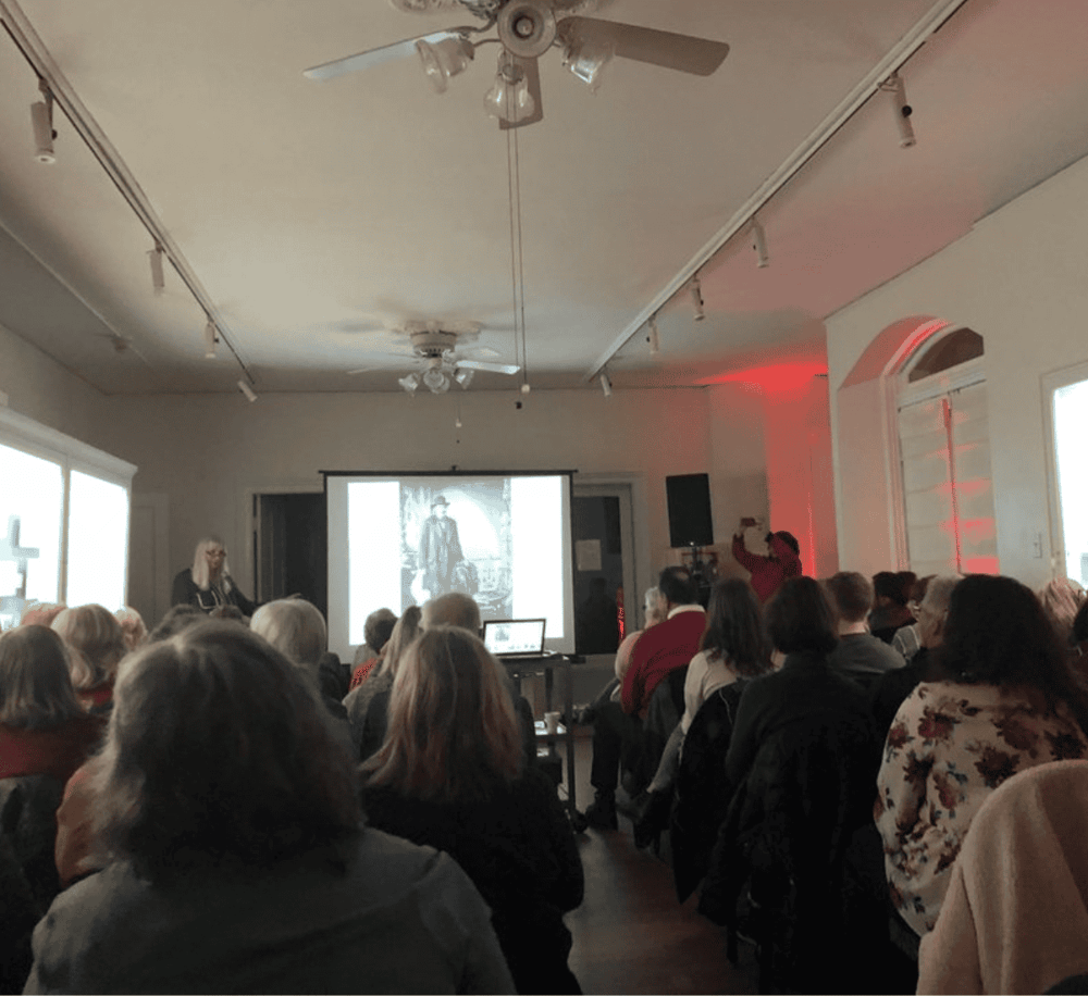 Historic speaker presentation at an indoor conference or event.