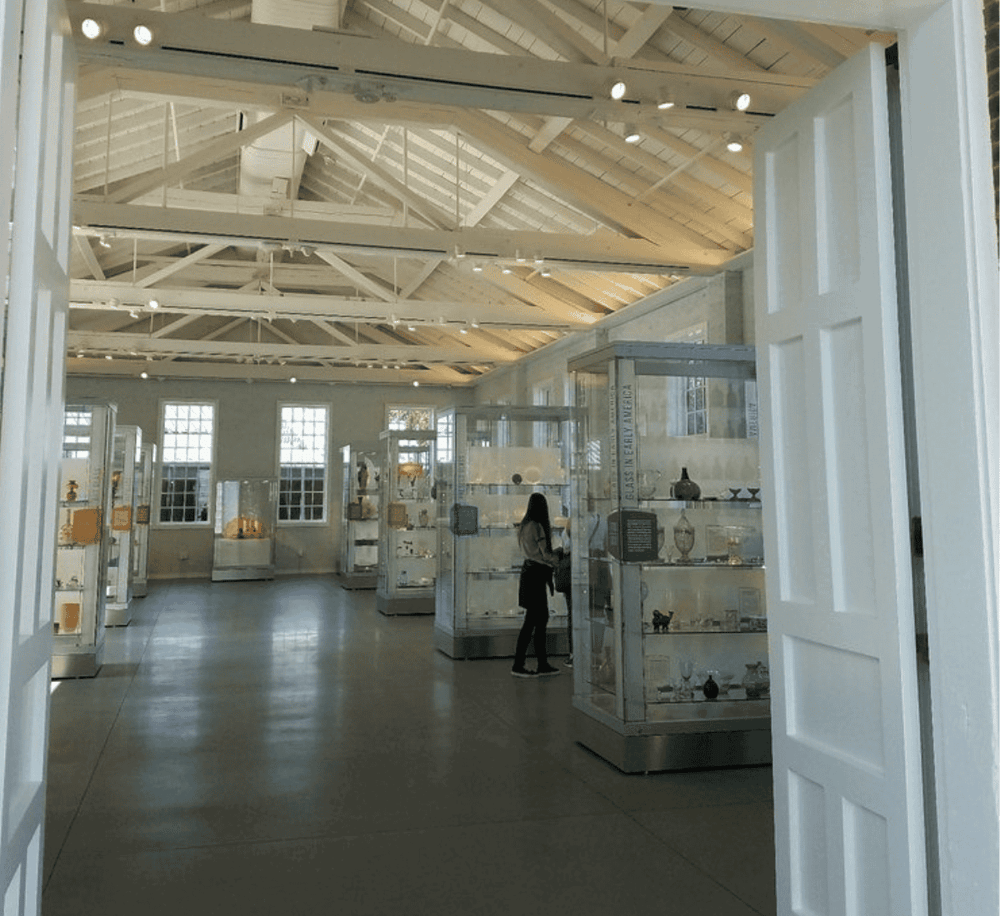 Bright museum interior showcasing glass display cases and high vaulted ceilings for art and history exhibitions.