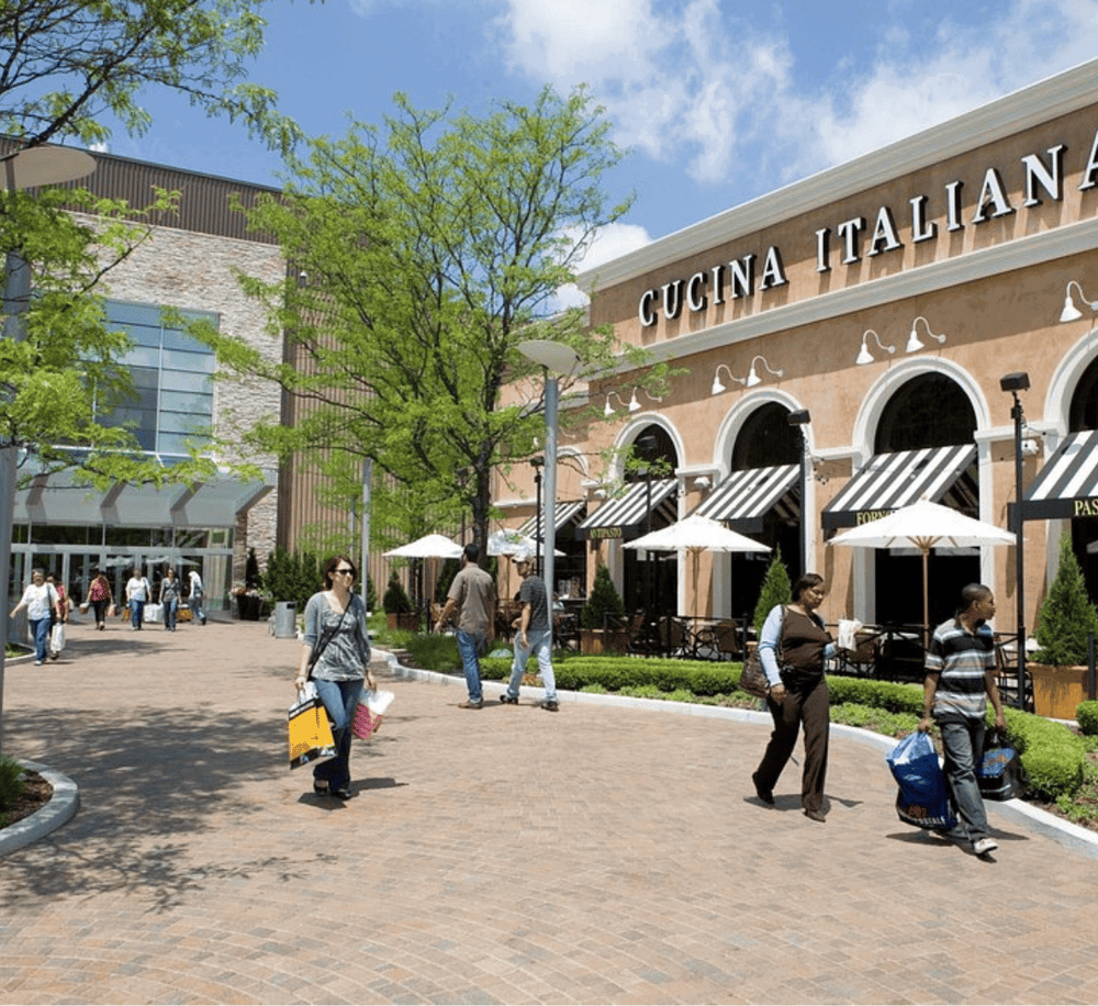 Modern shopping and dining outdoor plaza with Italian cuisine restaurants and shoppers.