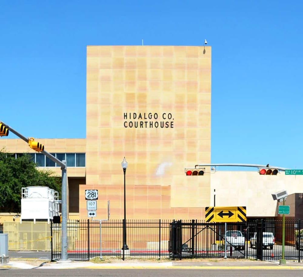 Historic Hidalgo County Courthouse in Texas showcases classic architecture and vibrant city surroundings.
