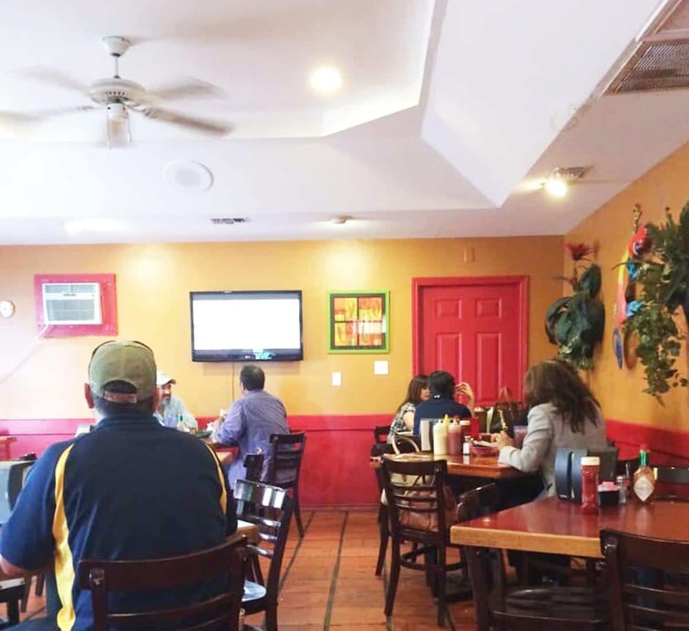 Comfortable restaurant interior with TV, cozy atmosphere, ideal for dining and socializing.