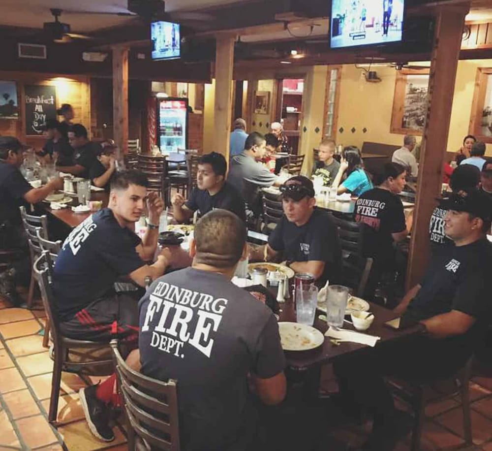 1. Firefighter crew dining at a restaurant, celebrating camaraderie and teamwork.