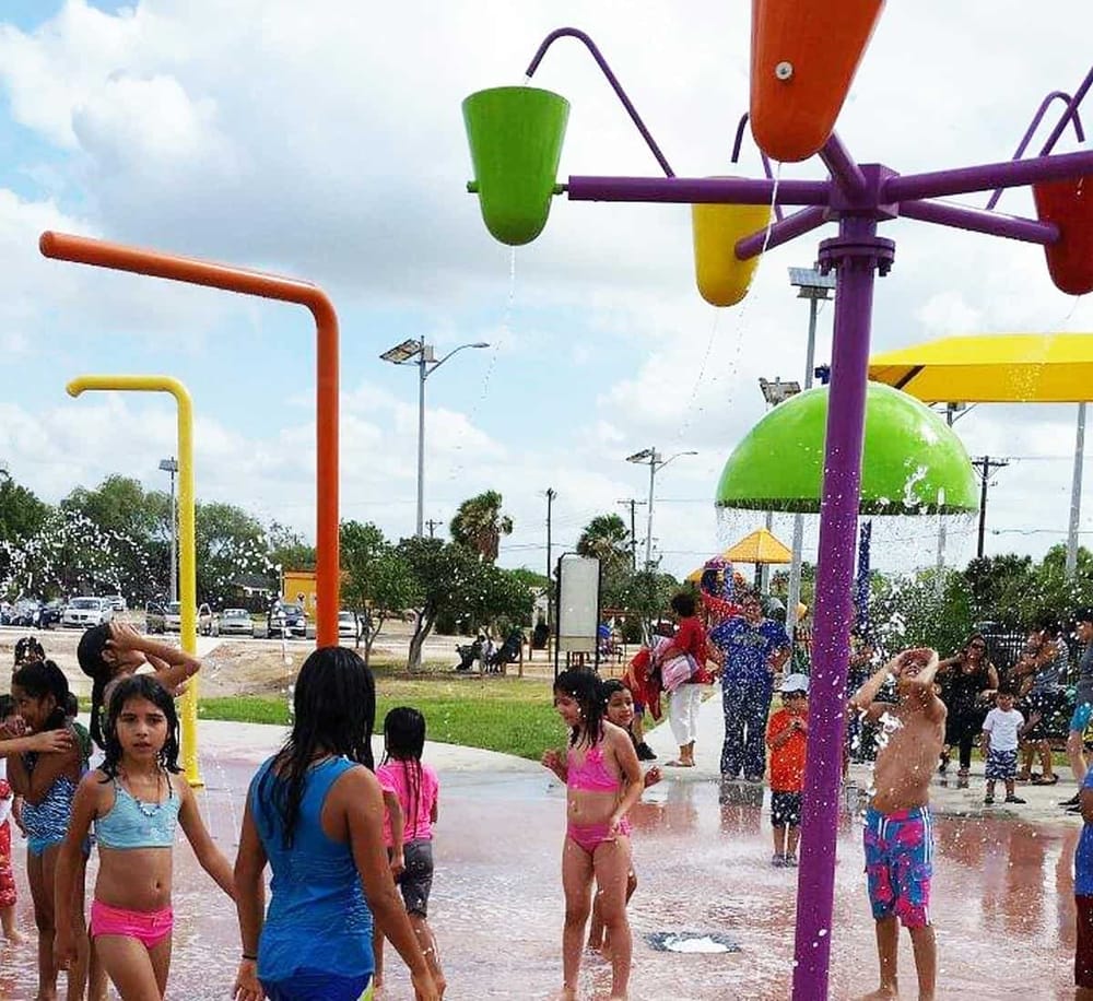Bright colorful water splash pads for kids at Quest For Directions, perfect for family fun and outdoor recreational activities.